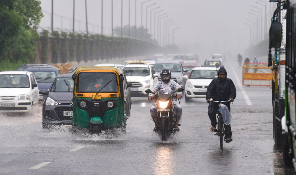 Vehicles wade through flooded streets after Delhi rains lead to yLsX7zkYODLffM scaled 1